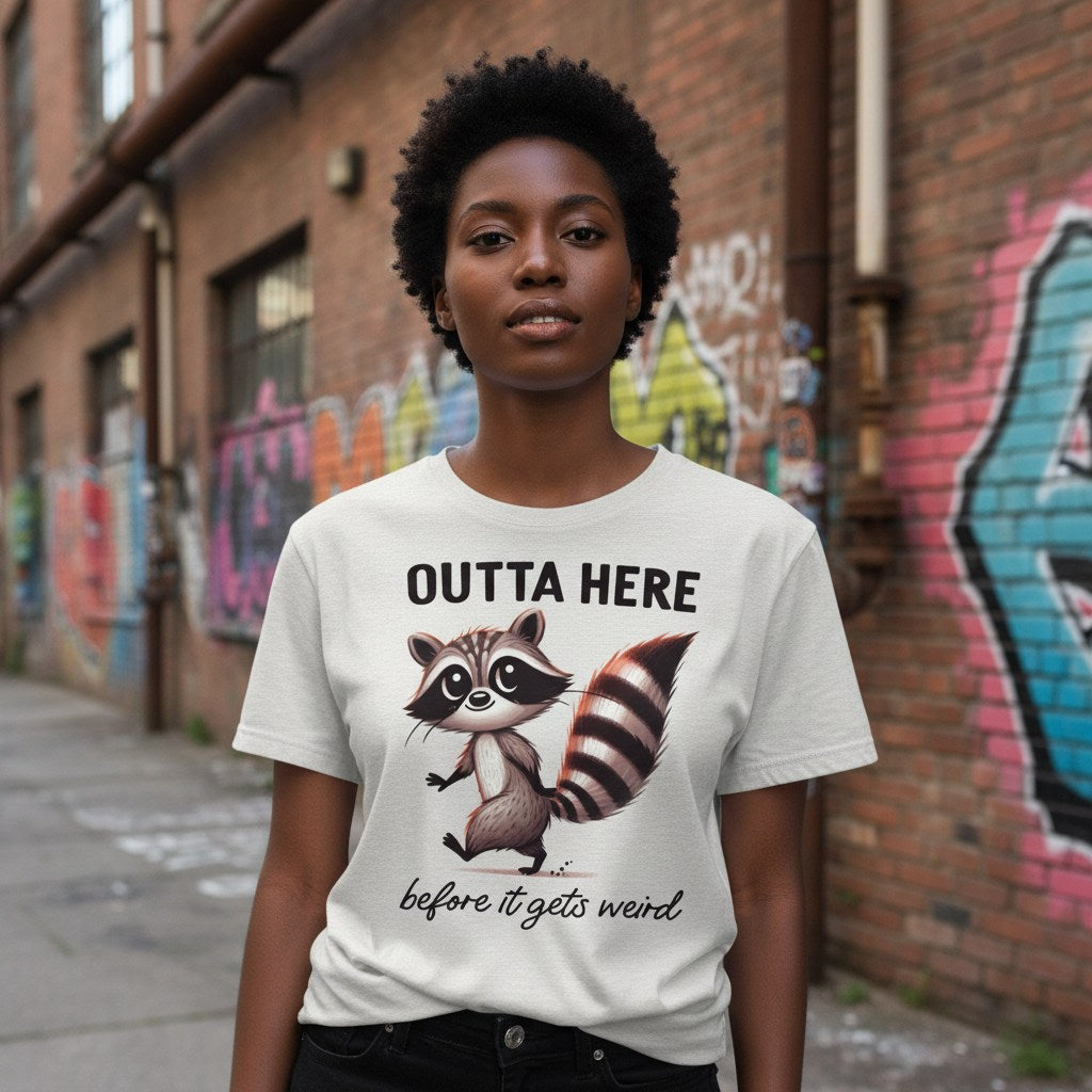 Person wearing a t-shirt with a raccoon graphic and text in an urban setting