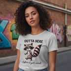 Woman wearing a t-shirt with a raccoon graphic and text in an urban setting