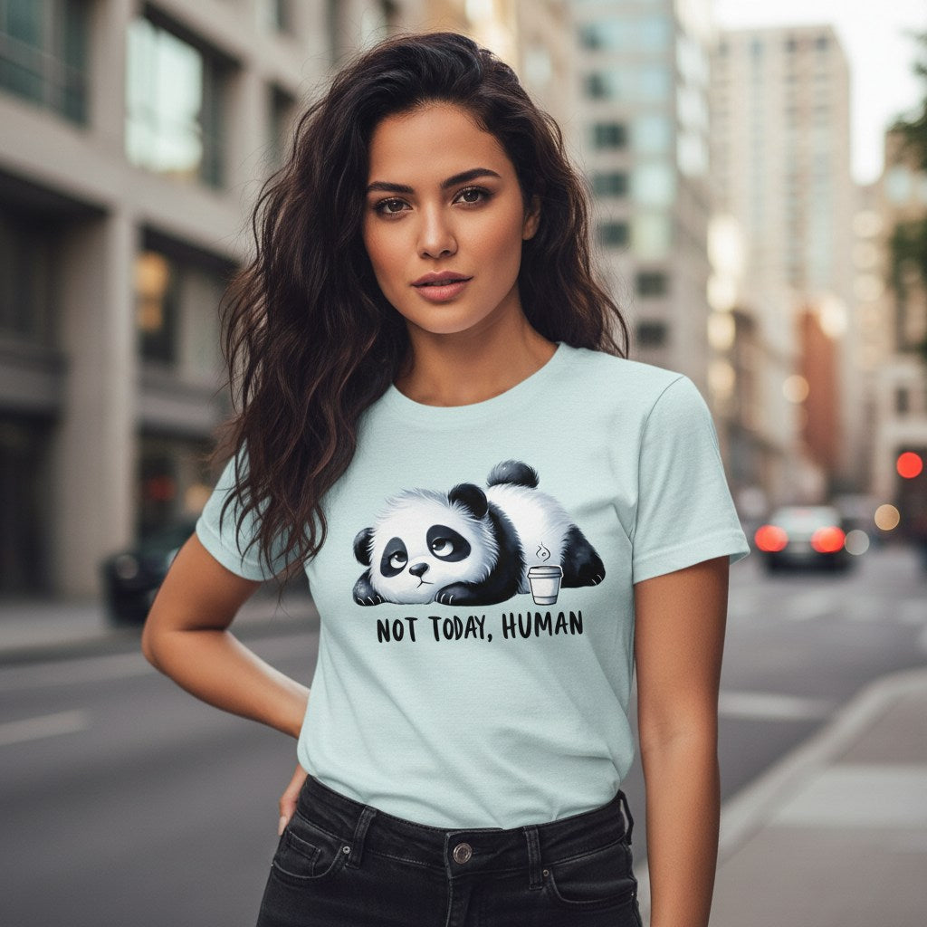 Woman wearing a light blue t-shirt with a panda graphic and text on a city street.