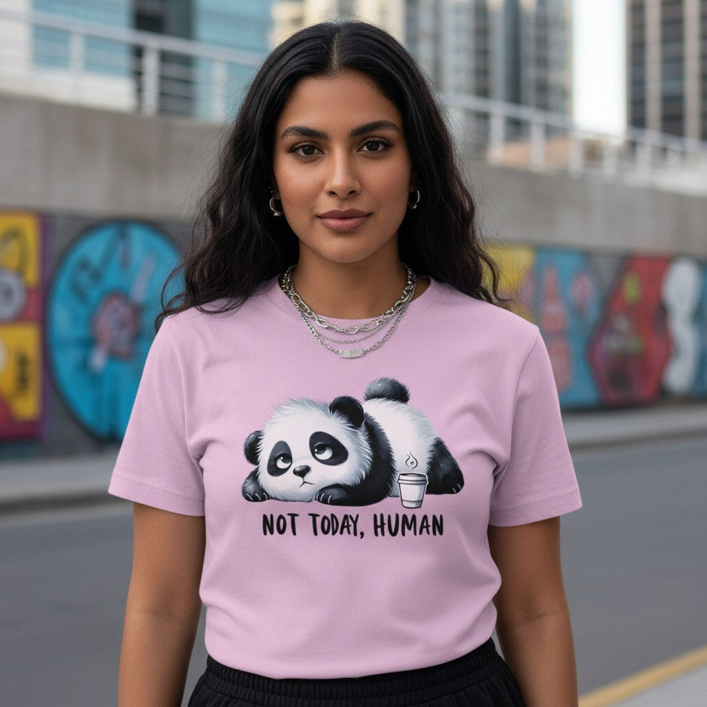 Woman wearing a pink t-shirt with a panda graphic and text, standing in an urban setting.