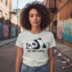 Woman wearing a t-shirt with a panda graphic and text in an urban setting