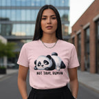 Woman wearing a pink t-shirt with a panda graphic and text in an urban setting