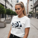Woman wearing a white t-shirt with a panda graphic and text in an urban setting