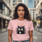 Woman wearing a pink t-shirt with a black cat graphic and text in an urban setting