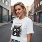 Woman wearing a white t-shirt with a black creature graphic and text on a city street.