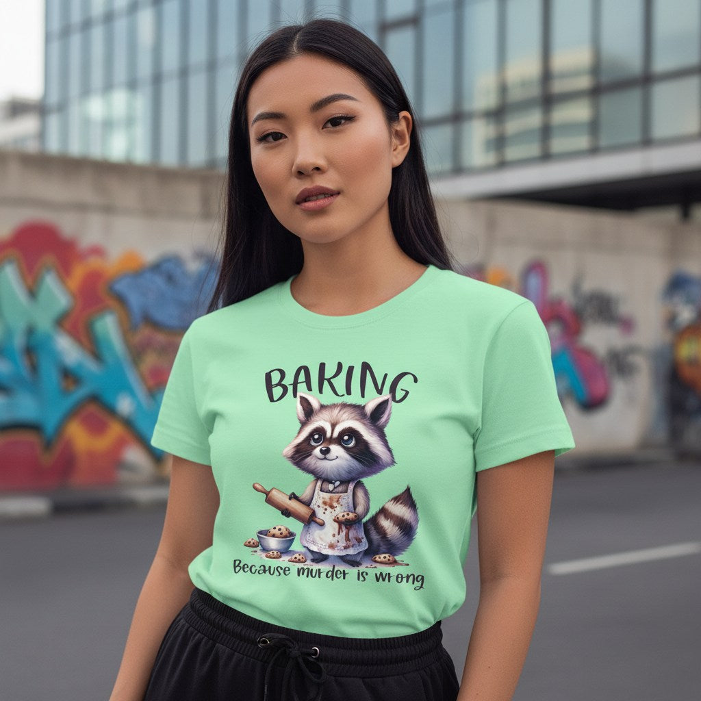 Woman wearing a light green t-shirt with a raccoon graphic and text, standing in an urban setting with graffiti.