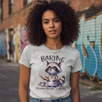 Person wearing a t-shirt with a raccoon graphic and text in an urban setting with graffiti.
