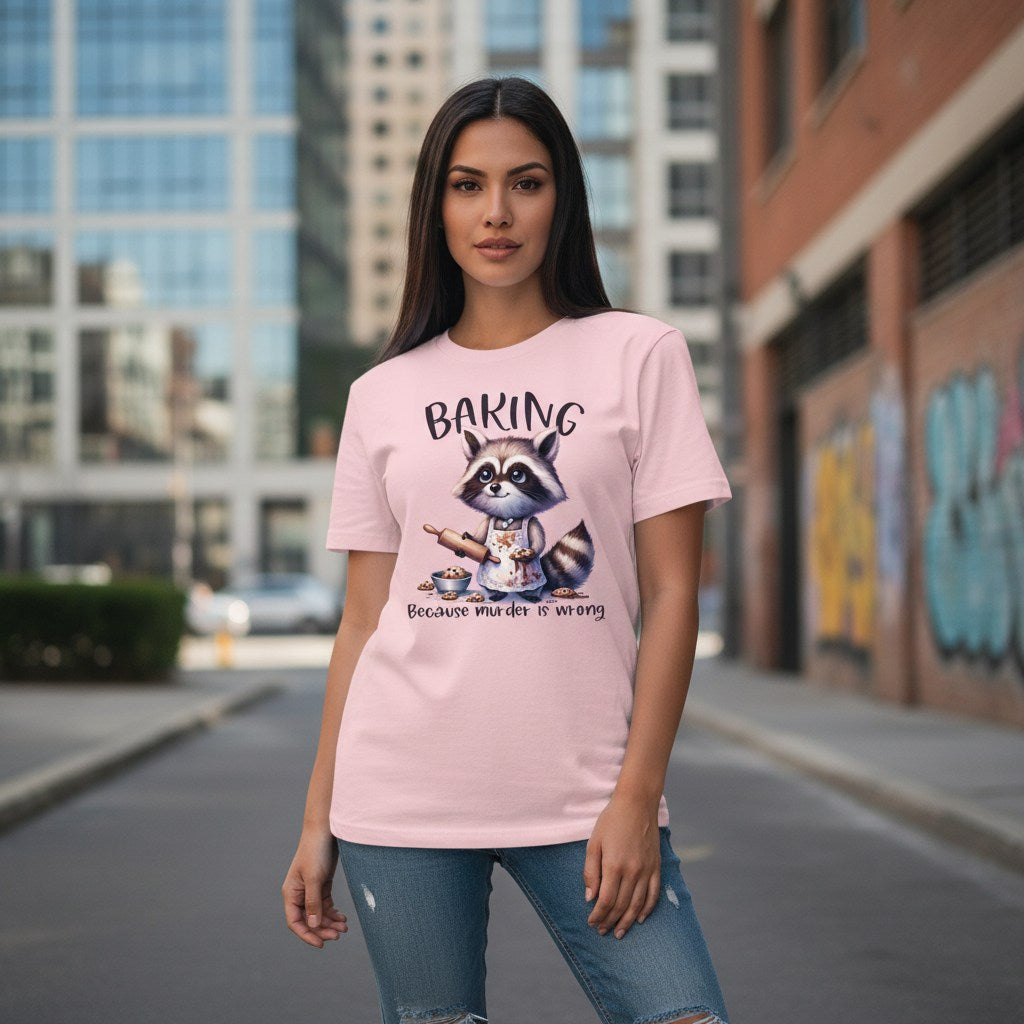 Woman wearing a pink t-shirt with a raccoon graphic and text on a city street.
