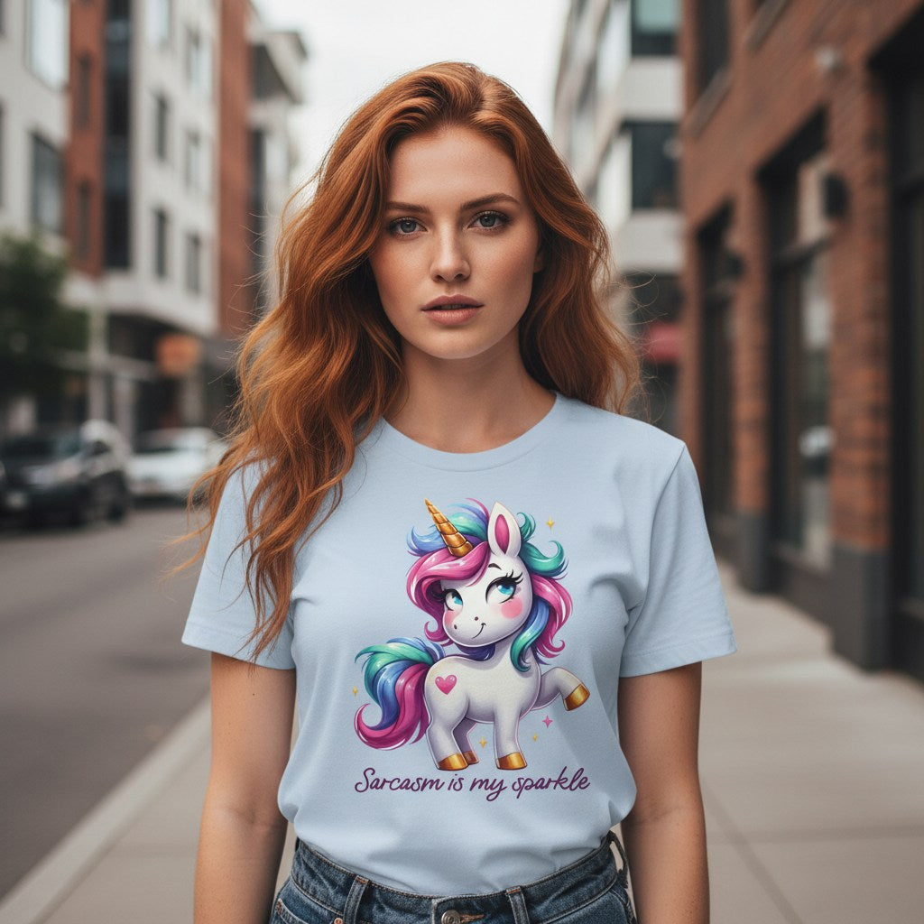 Woman wearing a light blue t-shirt with a unicorn graphic and text on a city street.