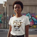 Person wearing a t-shirt with a sloth graphic and text in an urban setting with graffiti.
