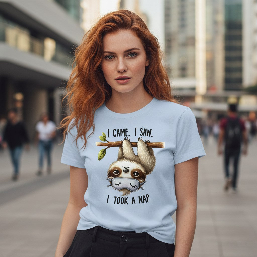 Woman wearing a light blue t-shirt with a sloth graphic and text in an urban setting