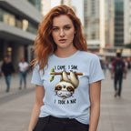 Woman wearing a light blue t-shirt with a sloth graphic and text in an urban setting