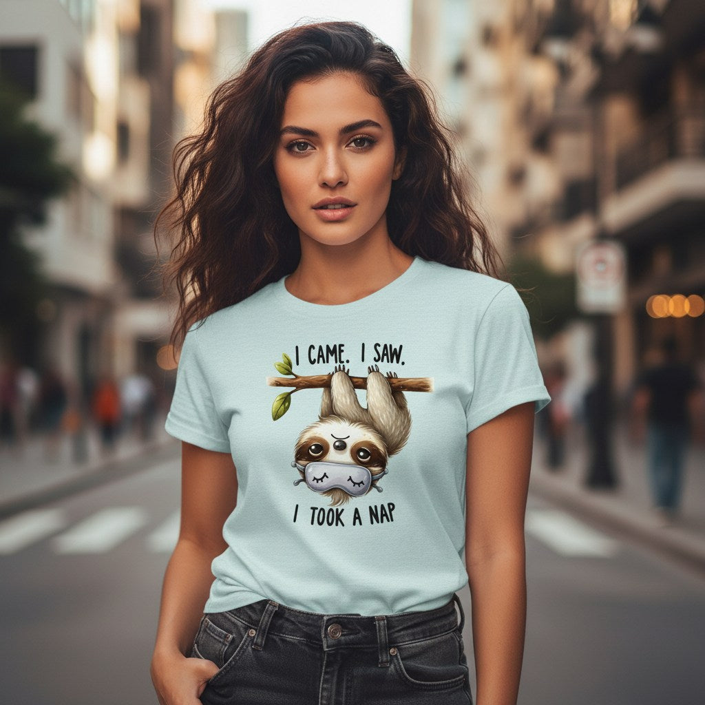Woman wearing a light blue t-shirt with a sloth graphic and text on a city street.
