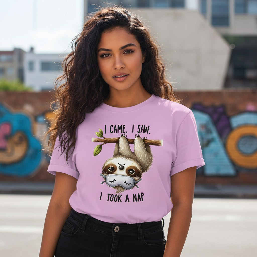 Woman wearing a pink t-shirt with a sloth graphic and text in an urban setting.