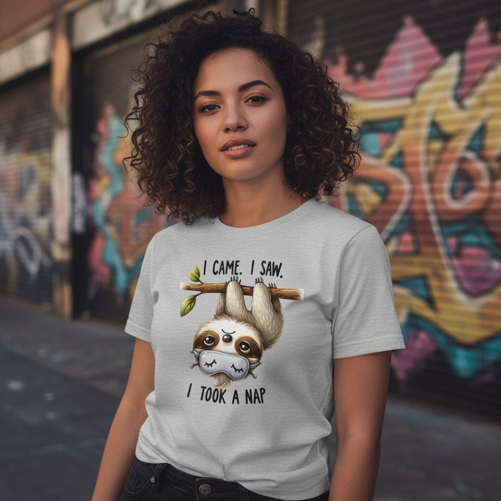 Person wearing a t-shirt with a sloth graphic and text in an urban setting with graffiti.
