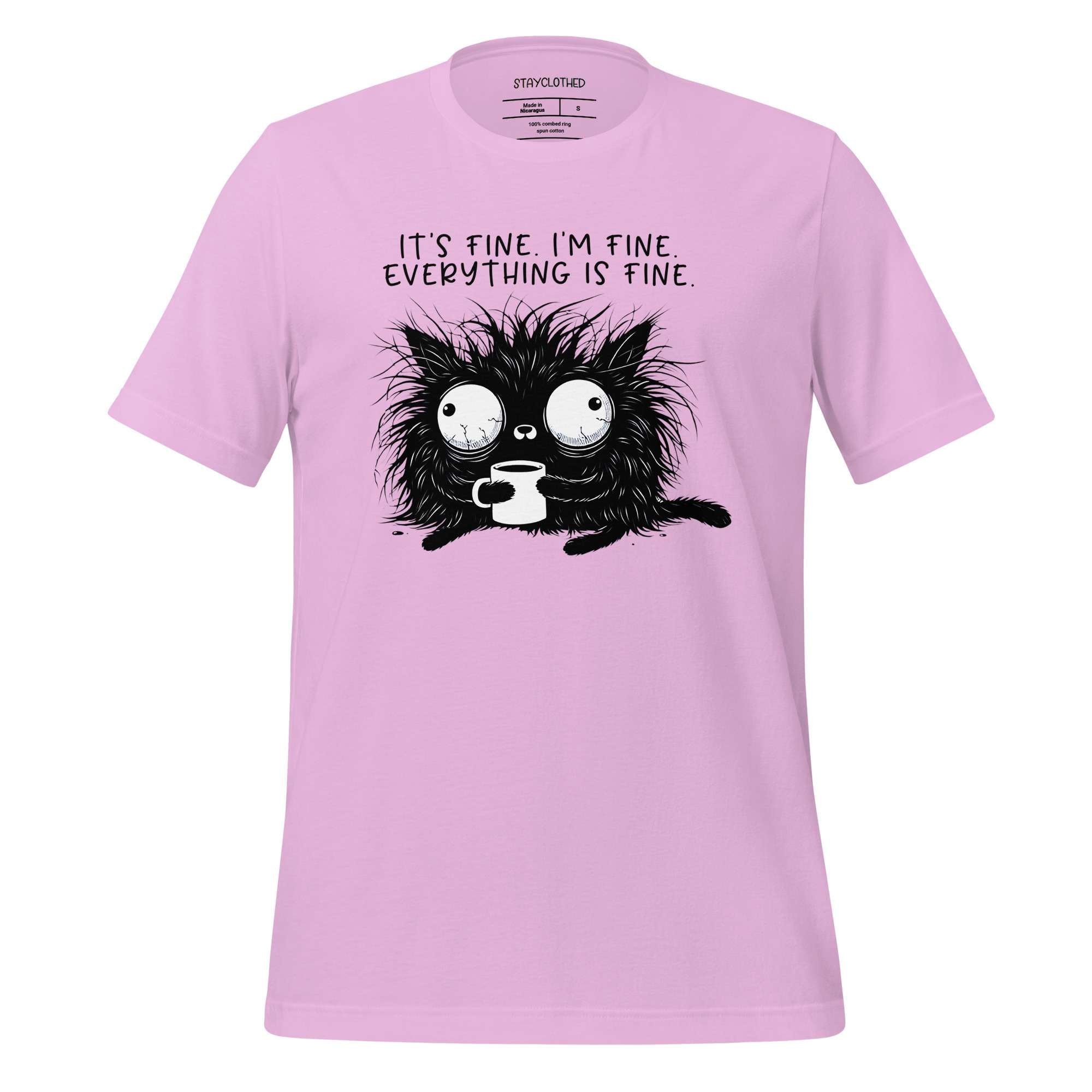 Pink t-shirt with a black cat graphic and text on a wooden surface, featuring the brand 'StayClothed'.