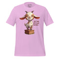 Pink t-shirt with a cartoon goat graphic and text on a wooden surface, featuring the brand 'StayClothed'.