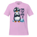 Pink t-shirt with a penguin graphic and text on a wooden surface, featuring the brand 'StayClothed'.