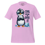 Pink t-shirt with a penguin graphic and text on a wooden surface, featuring the brand 'StayClothed'.