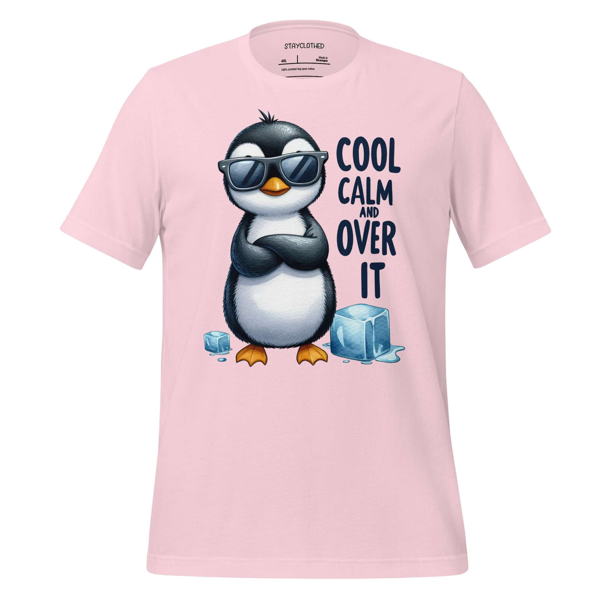 Pink t-shirt with a penguin graphic and text on a wooden surface, featuring the brand 'StayClothed'.
