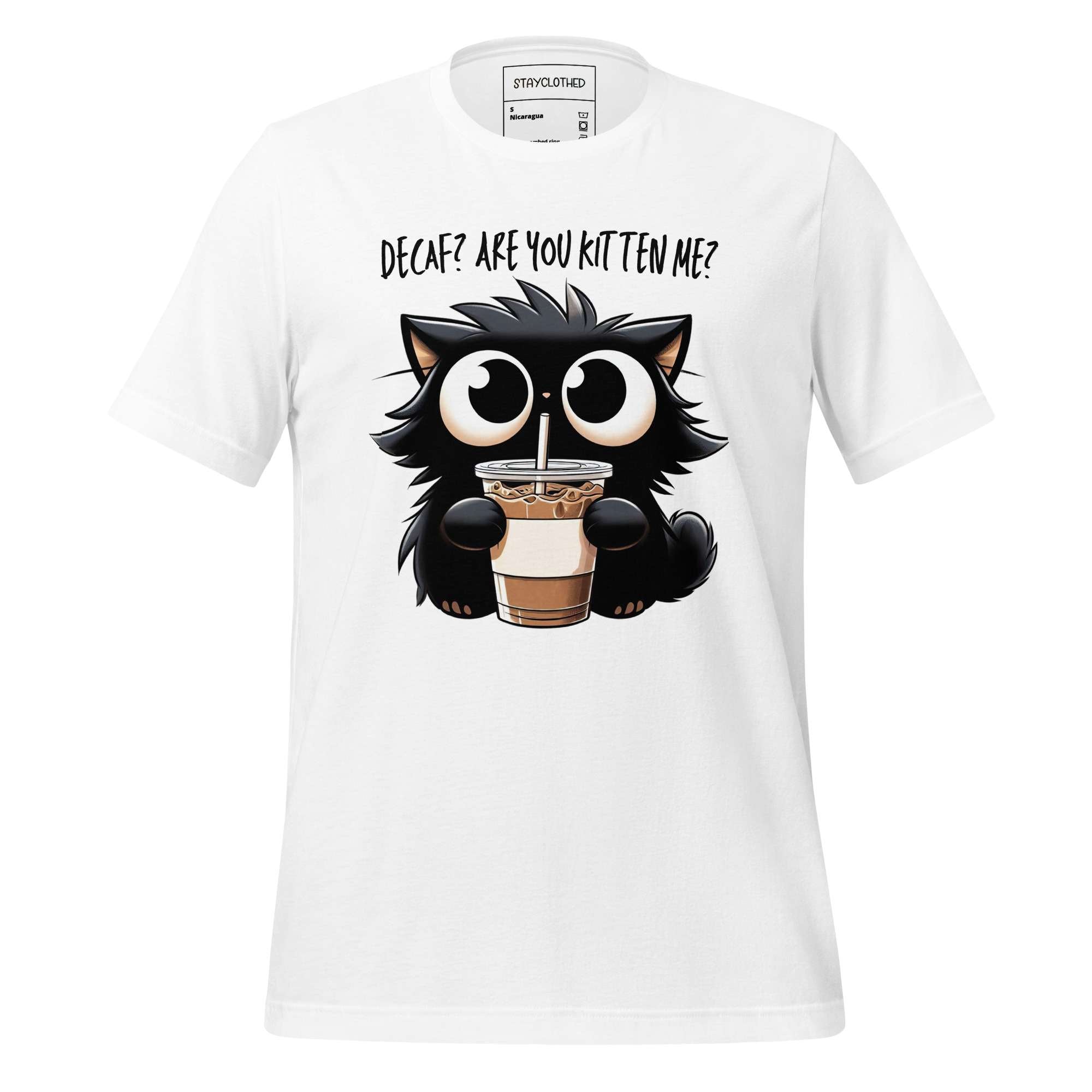 White t-shirt with a cat holding a drink graphic on a wooden surface, featuring the brand 'StayClothed'.