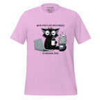 Pink t-shirt with a graphic of a cat and coffee cup on a wooden surface, featuring the brand 'StayClothed'.