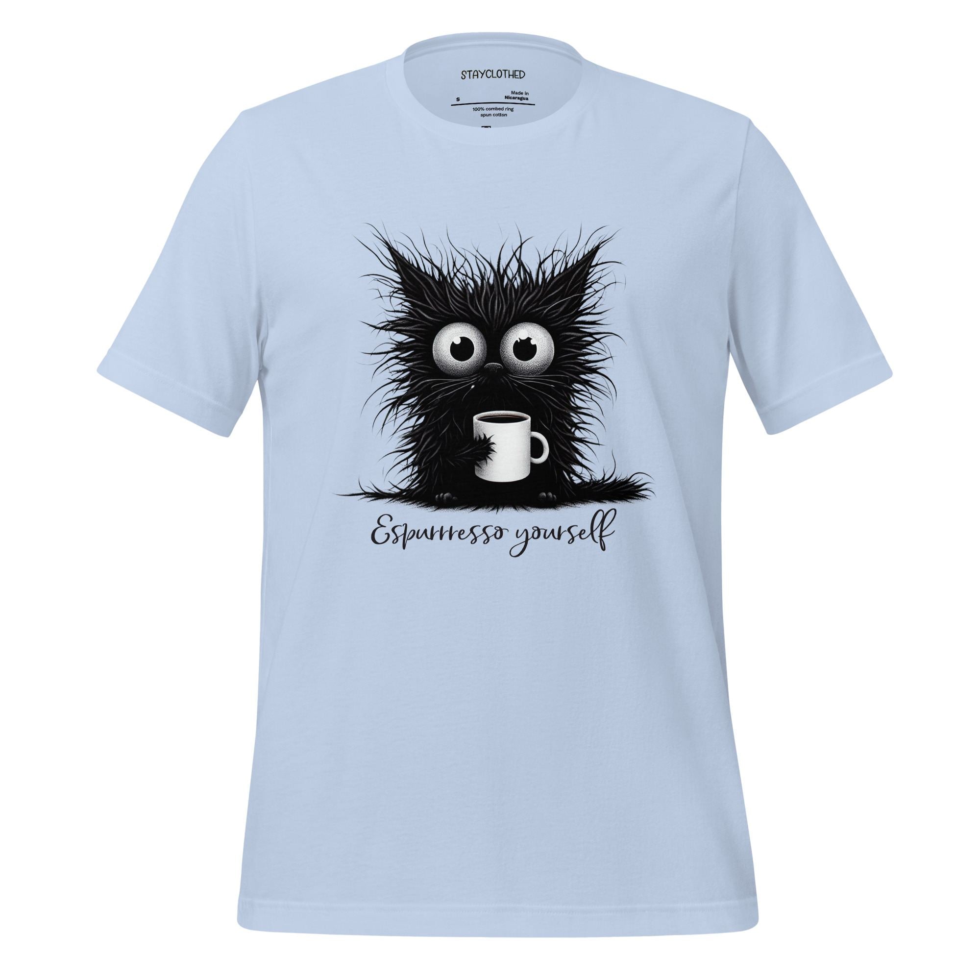 White t-shirt with a black cat graphic and 'Espressesso yourself' text on a wooden surface, featuring the brand 'StayClothed'.