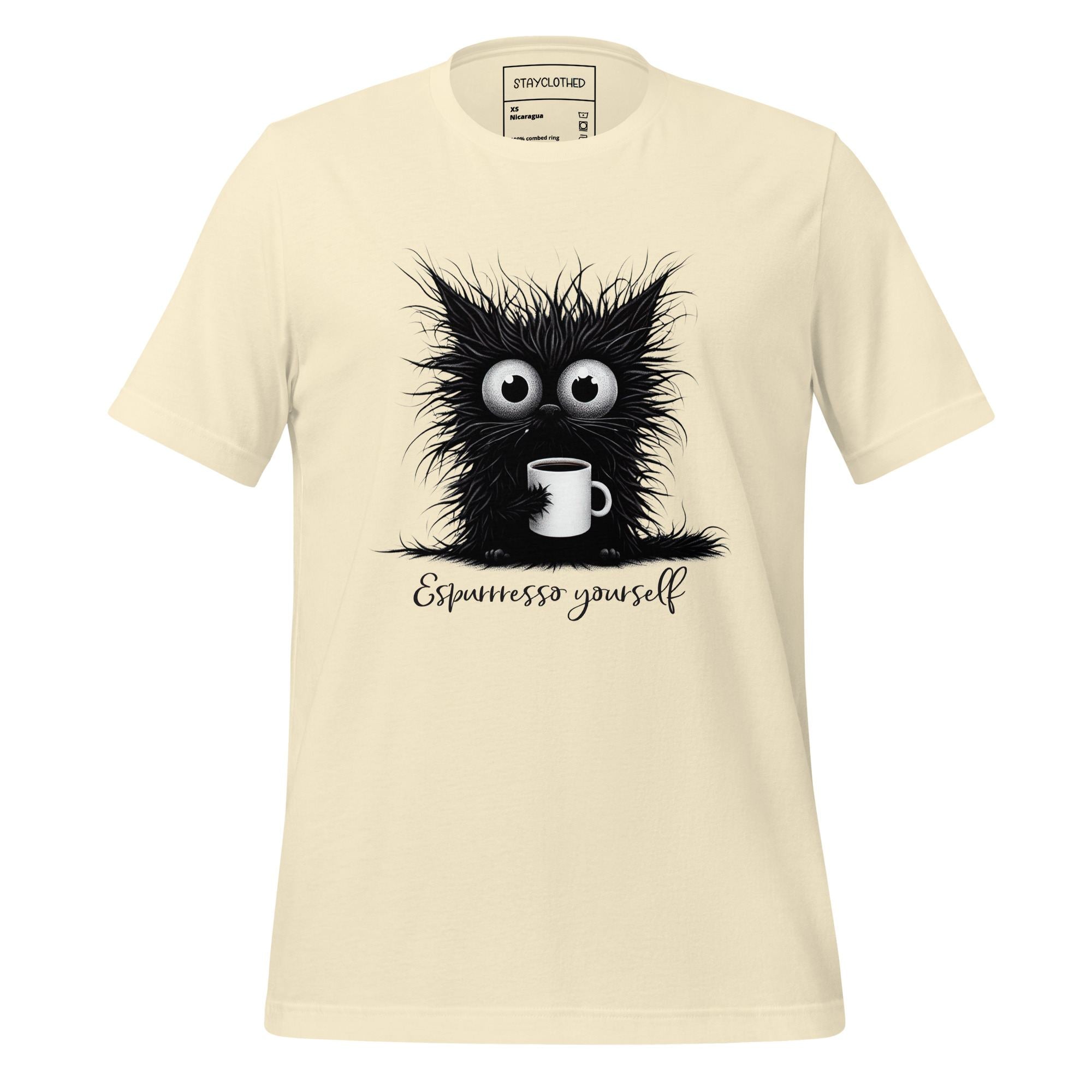Beige t-shirt with a black cat graphic and 'Espressesso yourself' text on a wooden surface, featuring the brand 'StayClothed'.