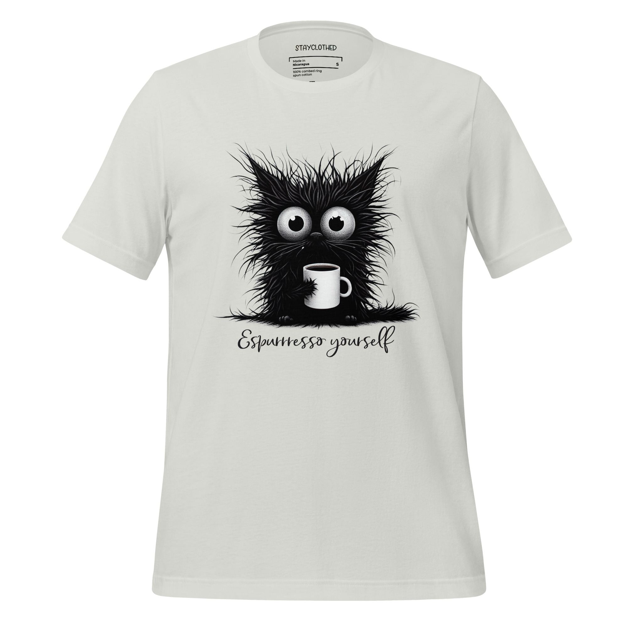 White t-shirt with a black cat holding a coffee cup design on a wooden surface, featuring the brand 'StayClothed'.