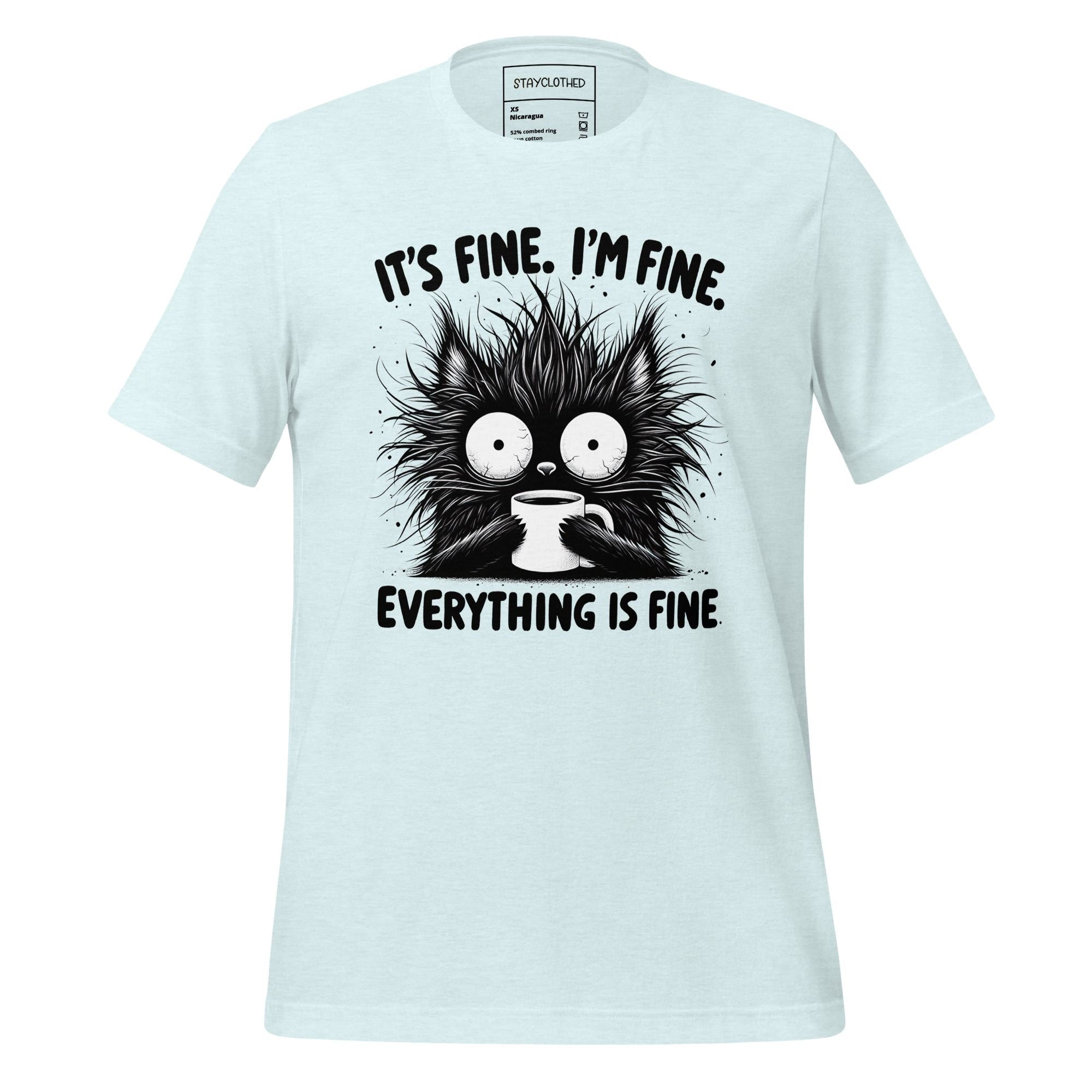 White t-shirt with a black cat graphic and text on a wooden surface, featuring the brand 'StayClothed'.