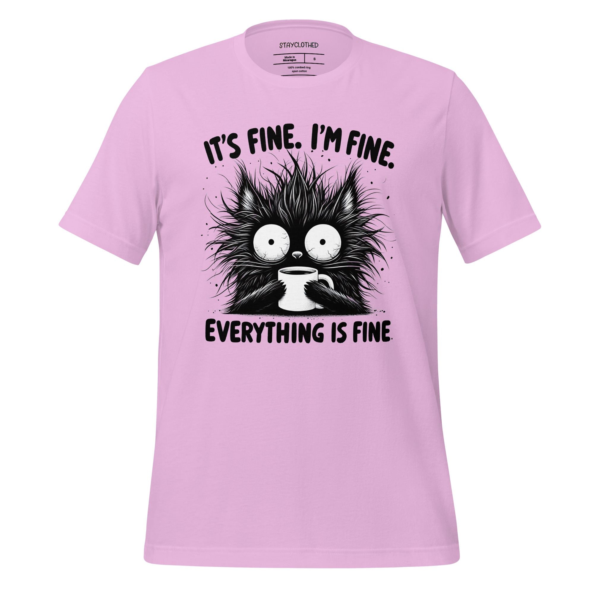 Pink t-shirt with a black cat graphic and text on a wooden surface, featuring the brand 'StayClothed'.