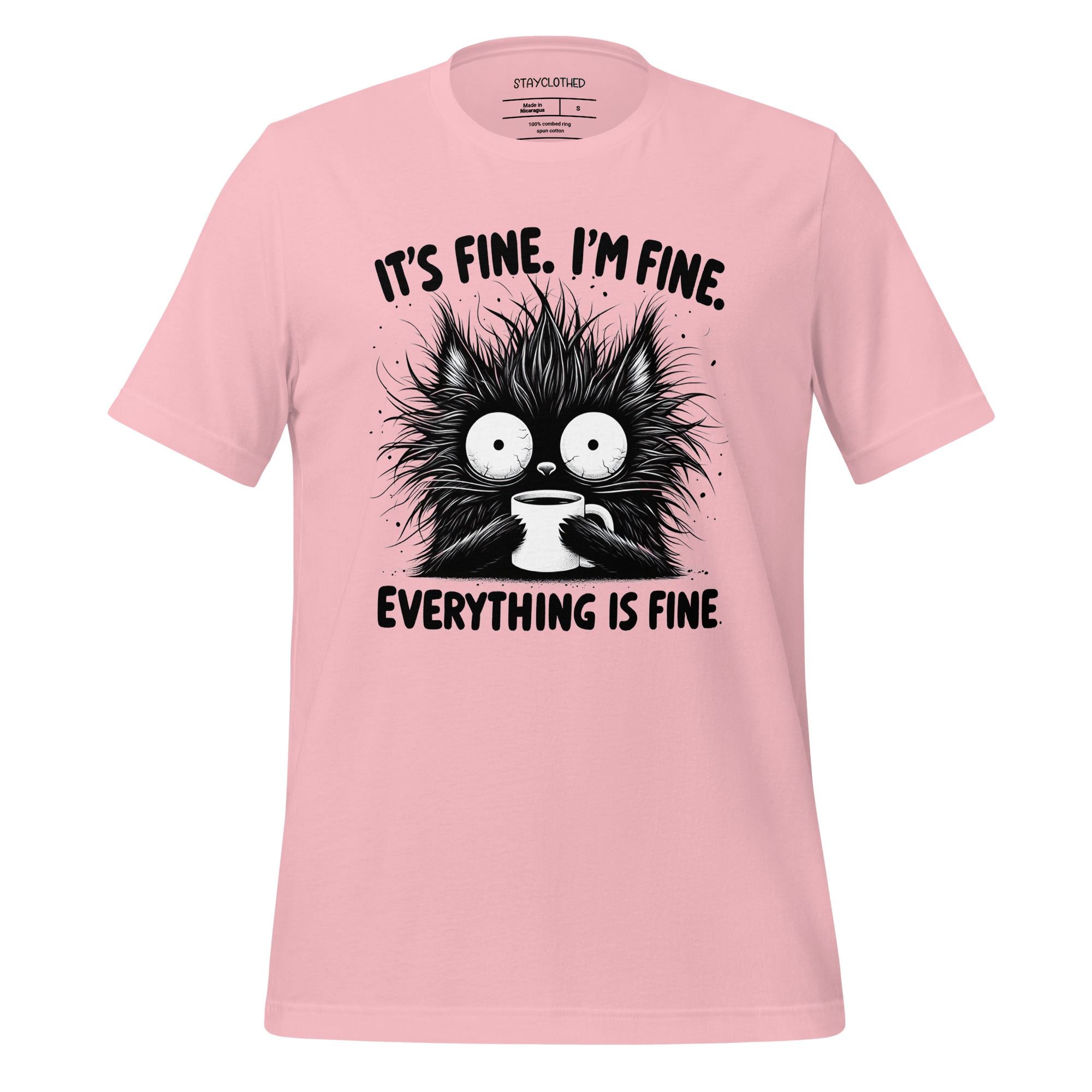 Pink t-shirt with a black cat graphic and text on a wooden surface, featuring the brand 'StayClothed'.