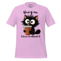 Pink t-shirt with a cartoon cat holding a drink on a wooden surface, featuring the brand 'StayClothed'.