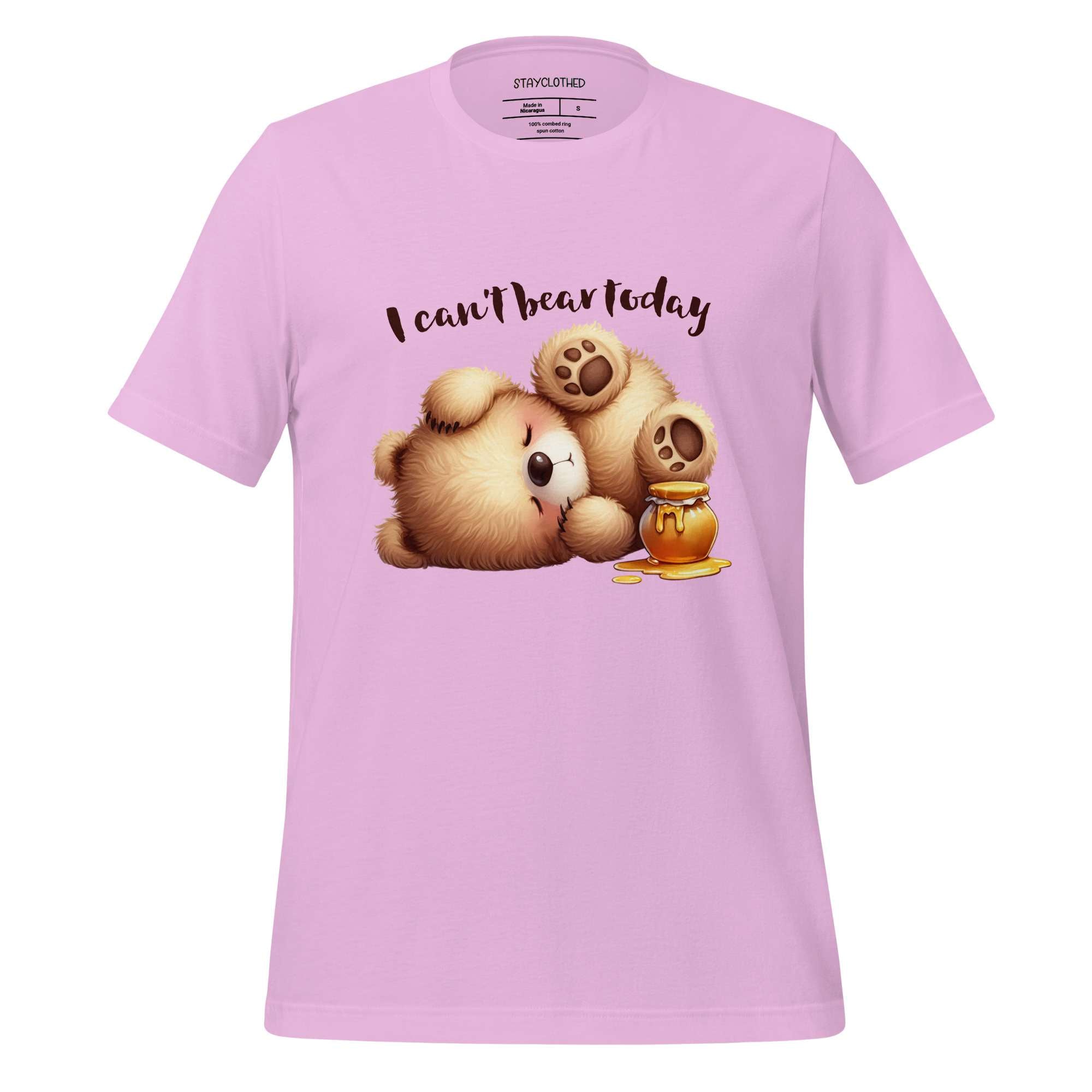 Pink t-shirt with teddy bear graphic and text 'I can't bear today' on a wooden surface, featuring the brand 'StayClothed'.
