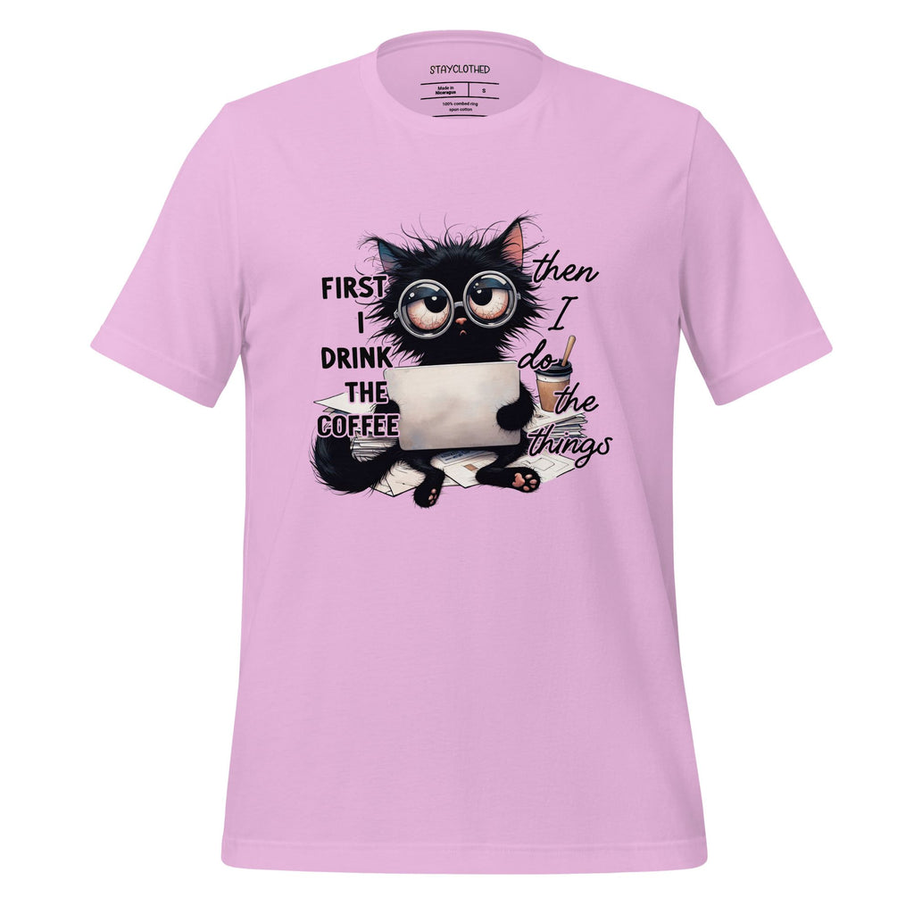 Pink t-shirt with a cat graphic and text on a wooden surface, featuring the brand 'StayClothed'.