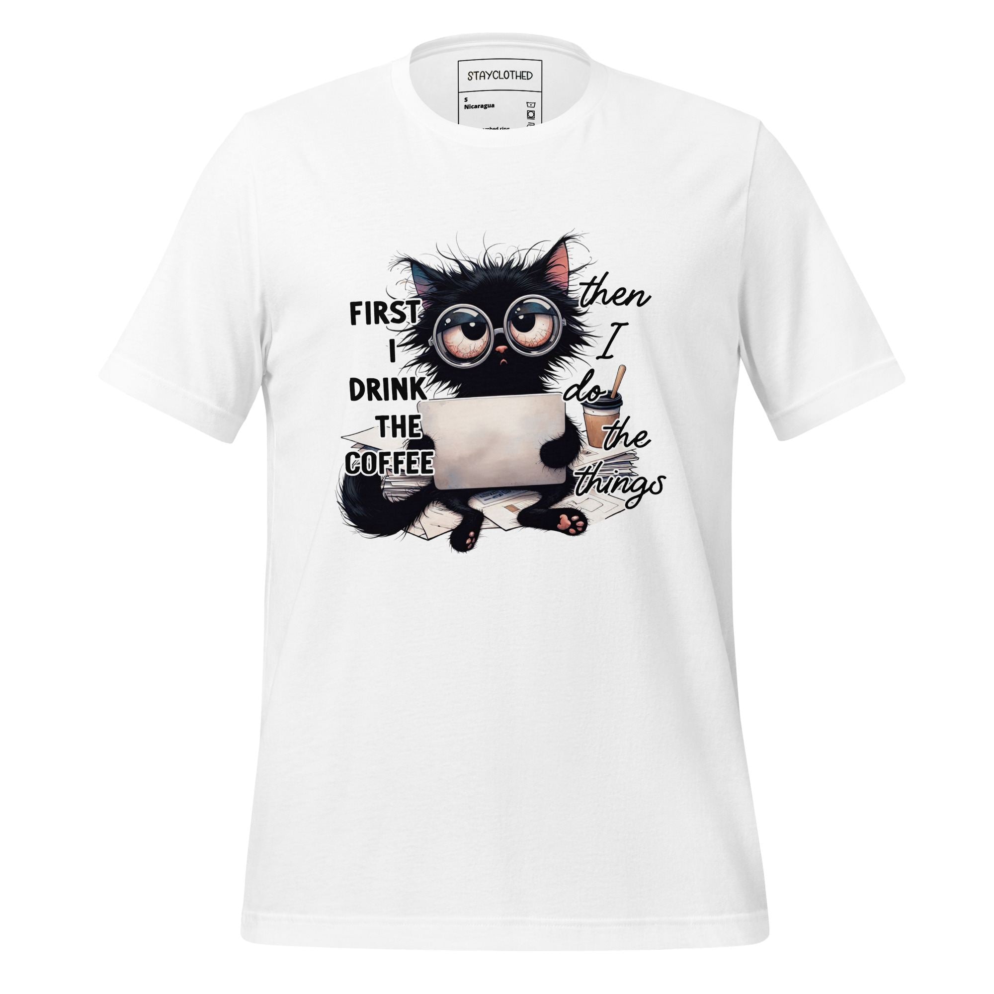 White t-shirt with a black cat graphic and text on a wooden surface, featuring the brand 'StayClothed'.