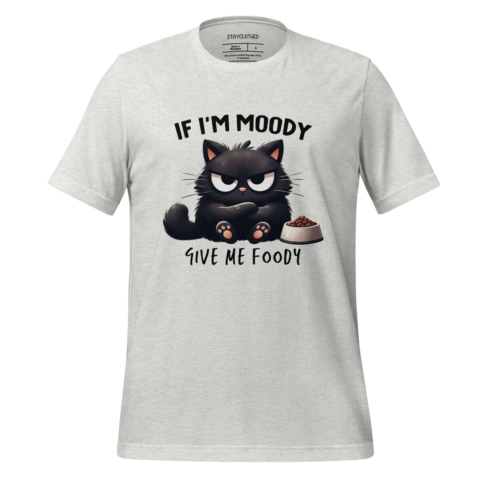 White t-shirt with a black cat graphic and text on a wooden surface, featuring the brand 'StayClothed'.