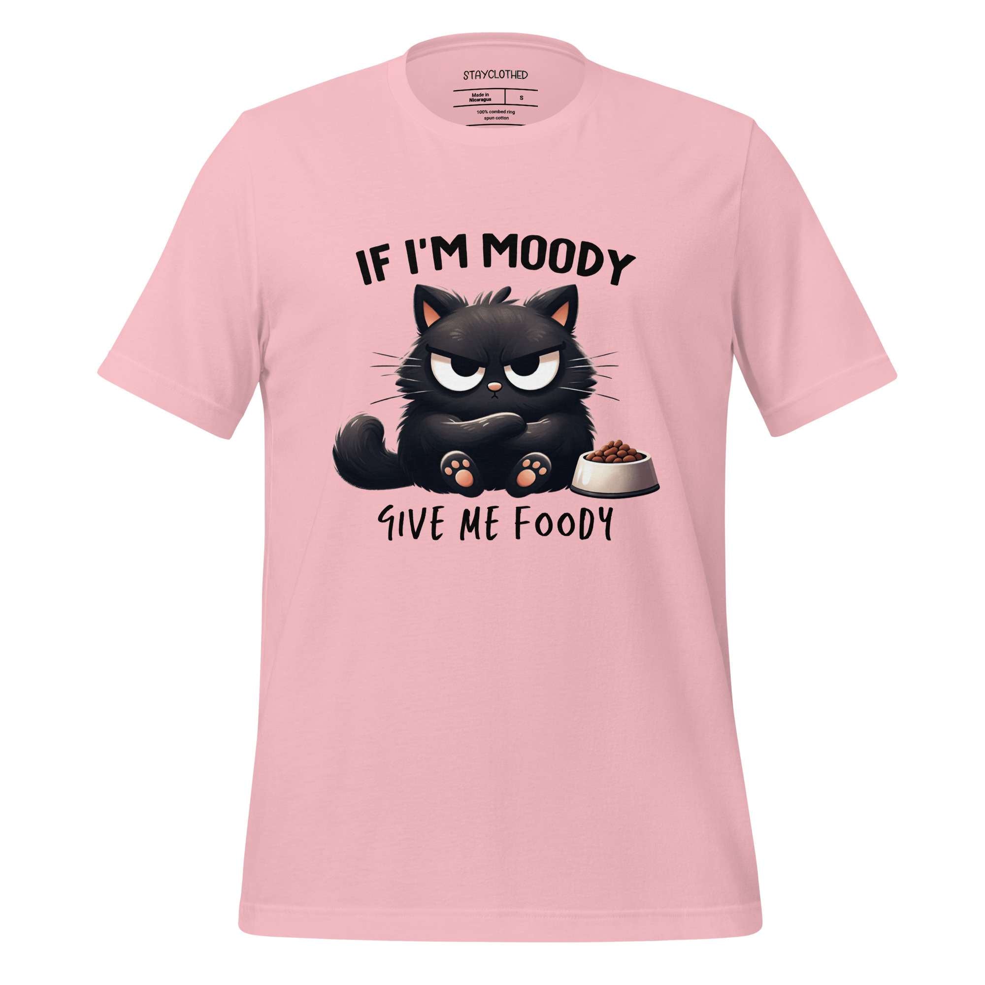Pink t-shirt with a black cat graphic and text on a wooden surface, featuring the brand 'StayClothed'.