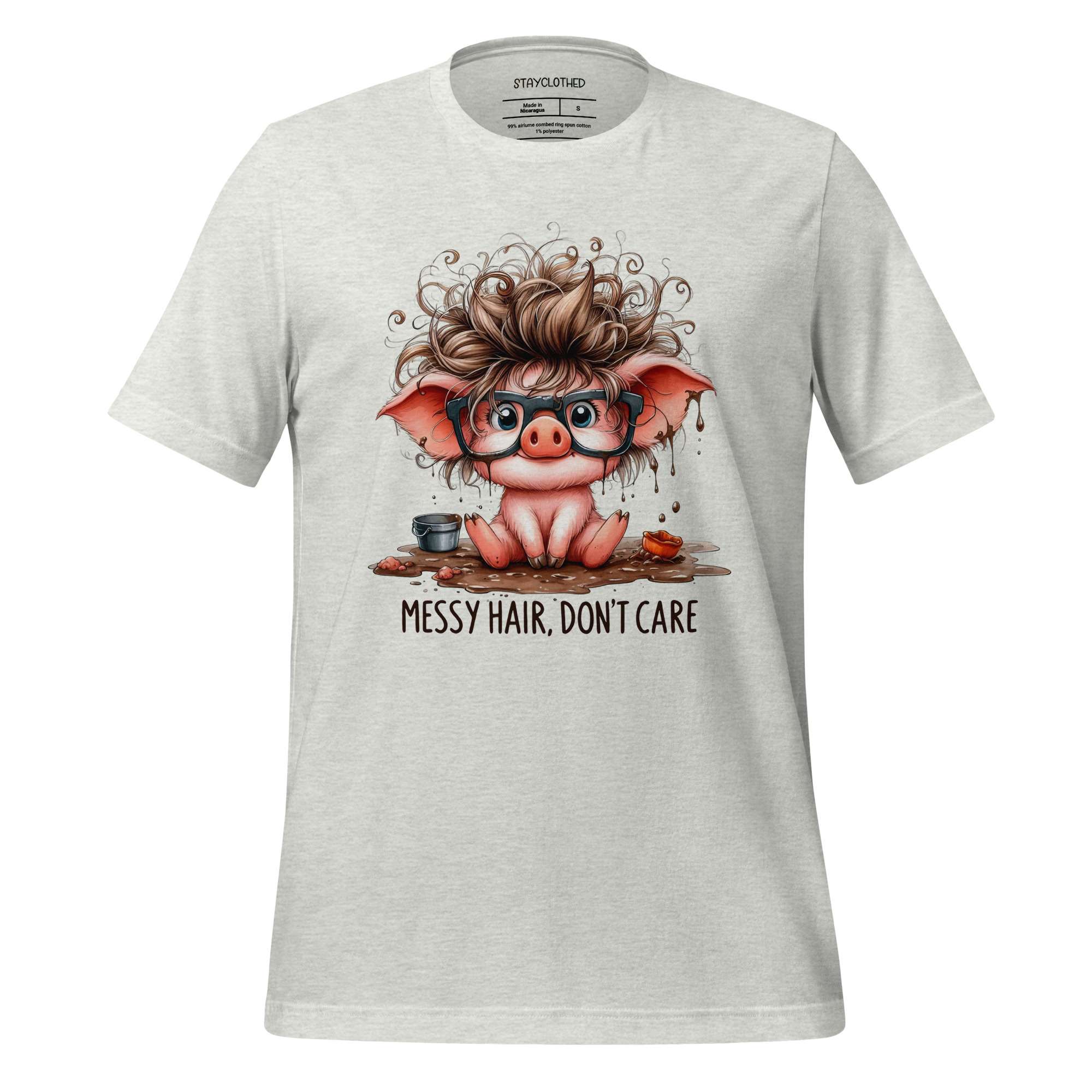 White t-shirt with a cartoon pig design and 'Messy Hair, Don't Care' text on a wooden background.