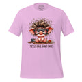 Pink t-shirt with a cartoon pig design and 'Messy Hair, Don't Care' text on a wooden surface.