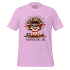 Pink t-shirt with a cartoon pig design and 'Messy Hair, Don't Care' text on a wooden surface.