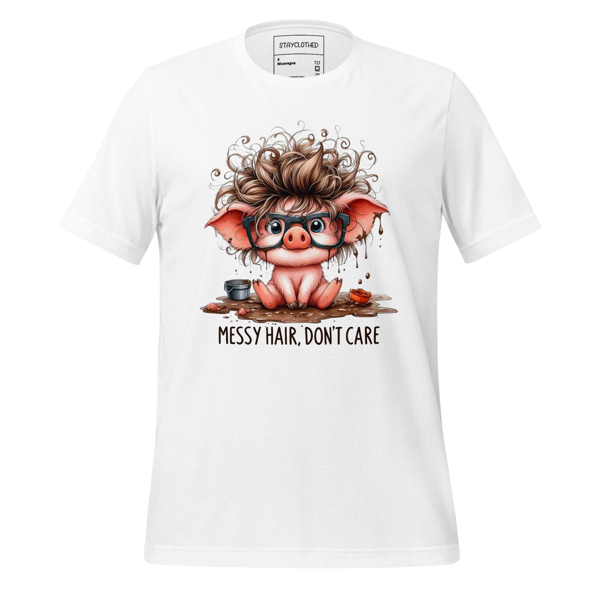 White t-shirt with a cartoon pig design and 'Messy Hair, Don't Care' text on a wooden surface, featuring the brand 'StayClothed'.