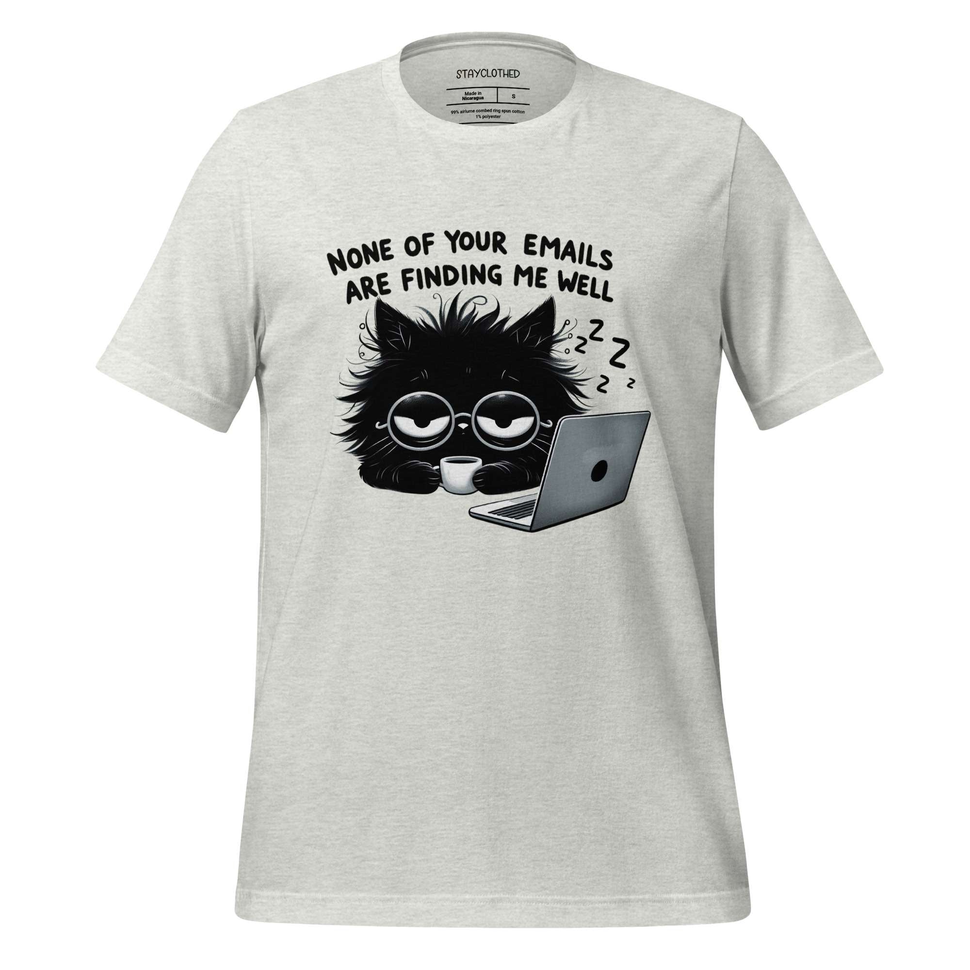 White t-shirt with a black cat graphic and text on a wooden surface, featuring the brand 'StayClothed'.