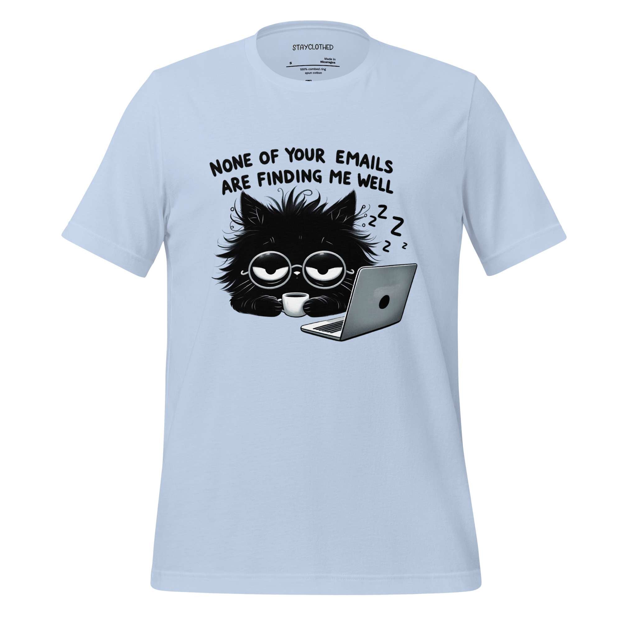 White t-shirt with a black cat graphic and text on a wooden surface, featuring the brand 'StayClothed'.