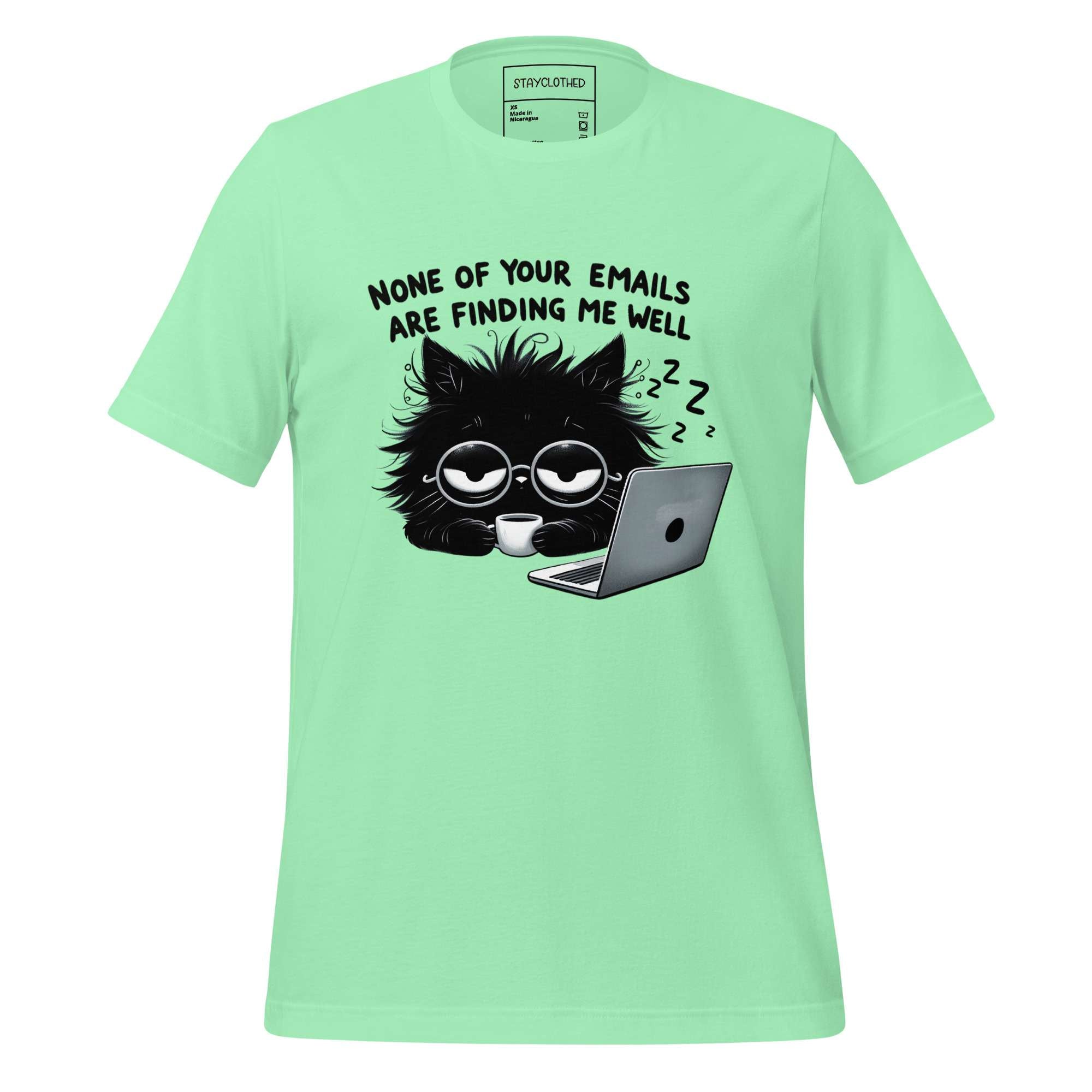 Light green t-shirt with a black cat graphic and text on a wooden surface, featuring the brand 'StayClothed'.