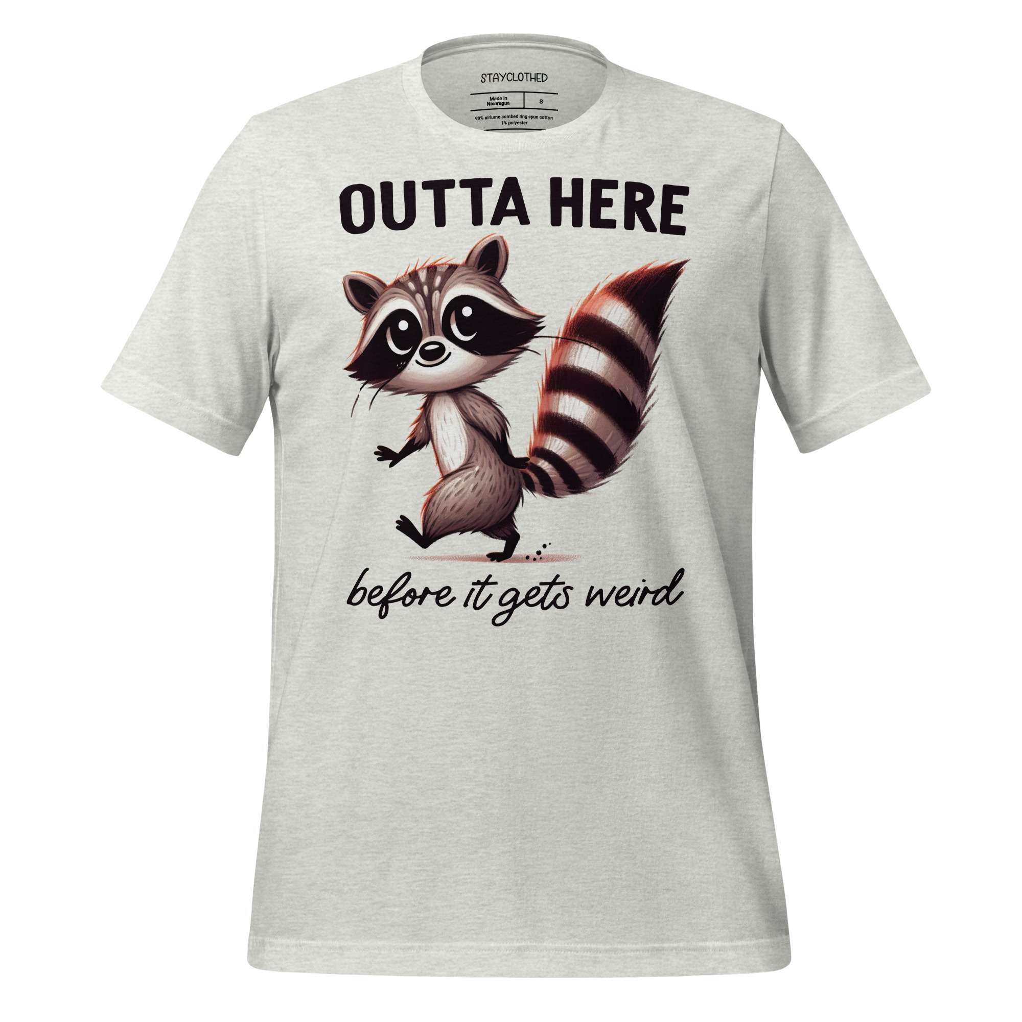 White t-shirt with a raccoon graphic and text on a wooden surface, featuring the brand 'StayClothed'.
