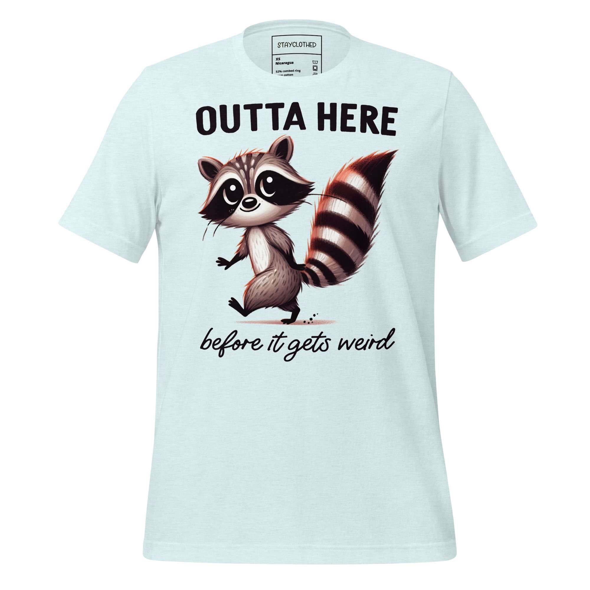 White t-shirt with a raccoon graphic and text on a wooden surface, featuring the brand 'StayClothed'.