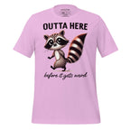 Pink t-shirt with a raccoon graphic and text on a wooden surface, featuring the brand 'StayClothed'.