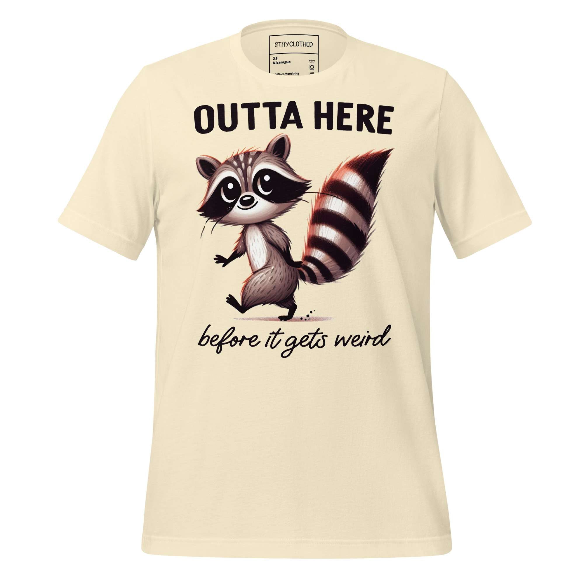 Beige t-shirt with a raccoon graphic and text on a wooden surface, featuring the brand 'StayClothed'.