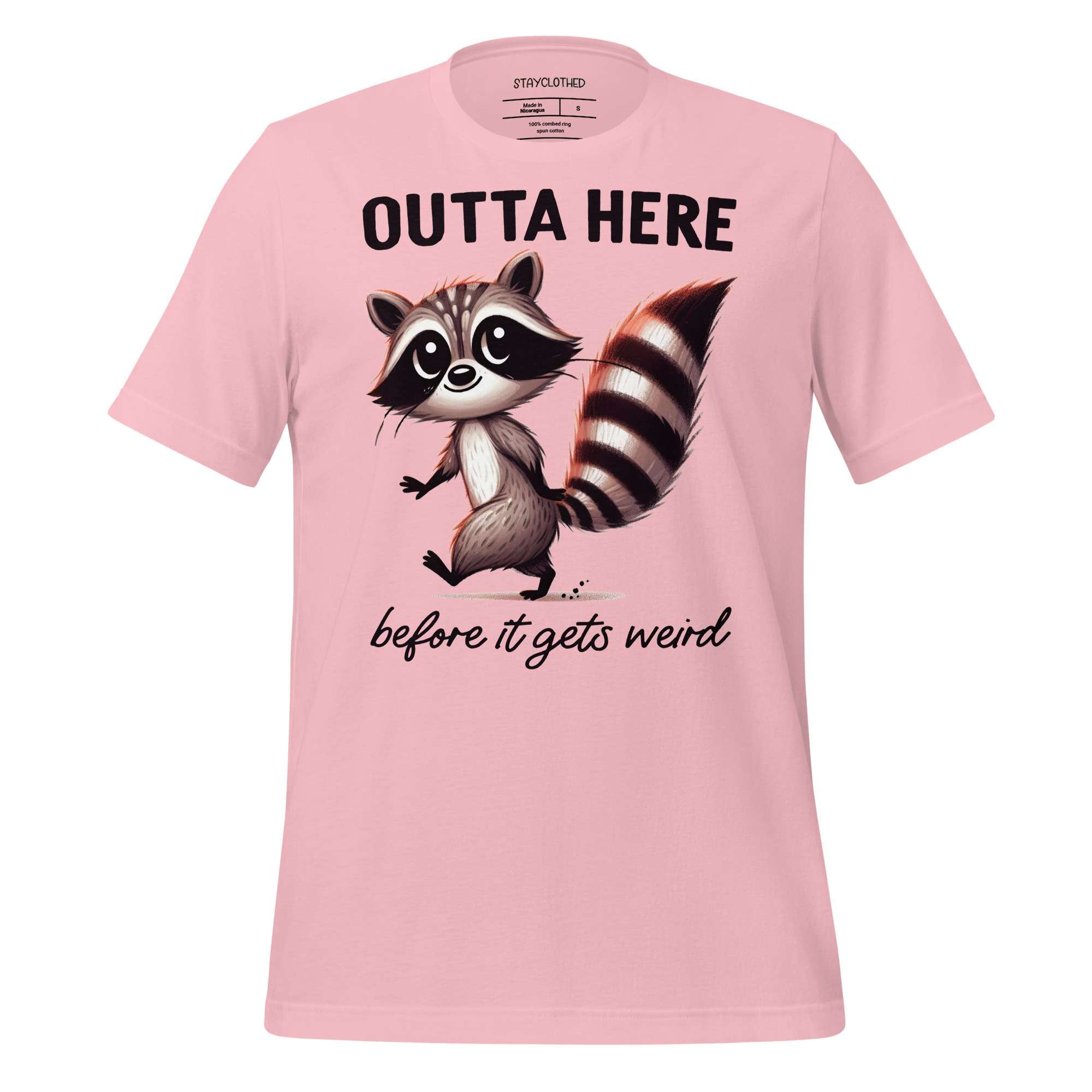 Pink t-shirt with a raccoon graphic and text on a wooden surface, featuring the brand 'StayClothed'.